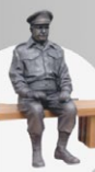 Sculpture of Captain Mainwaring from Dad's Army sitting on a bench